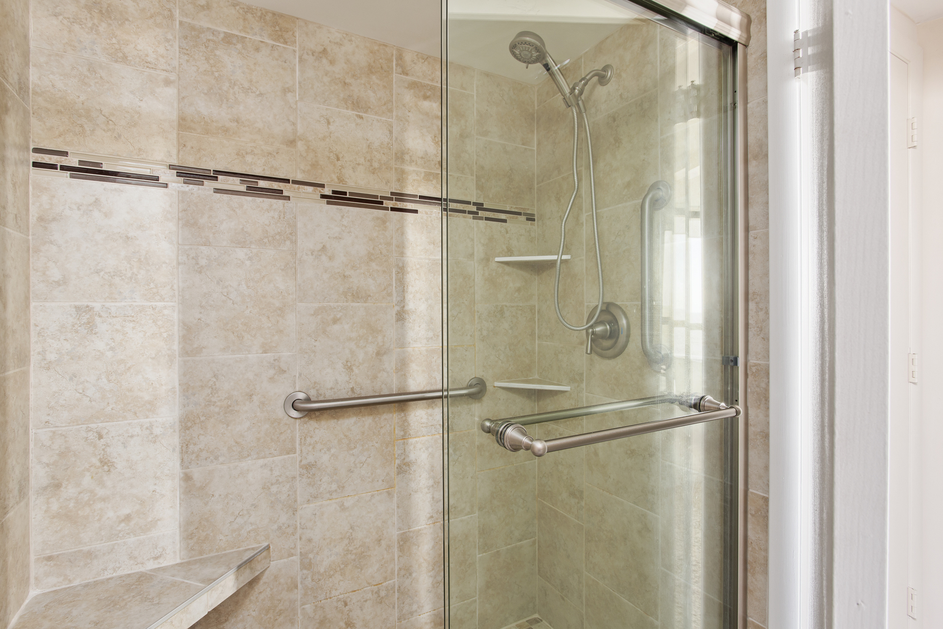 Rinse off the Summer Sun in the refreshing Custom Tile Walk-In Shower.