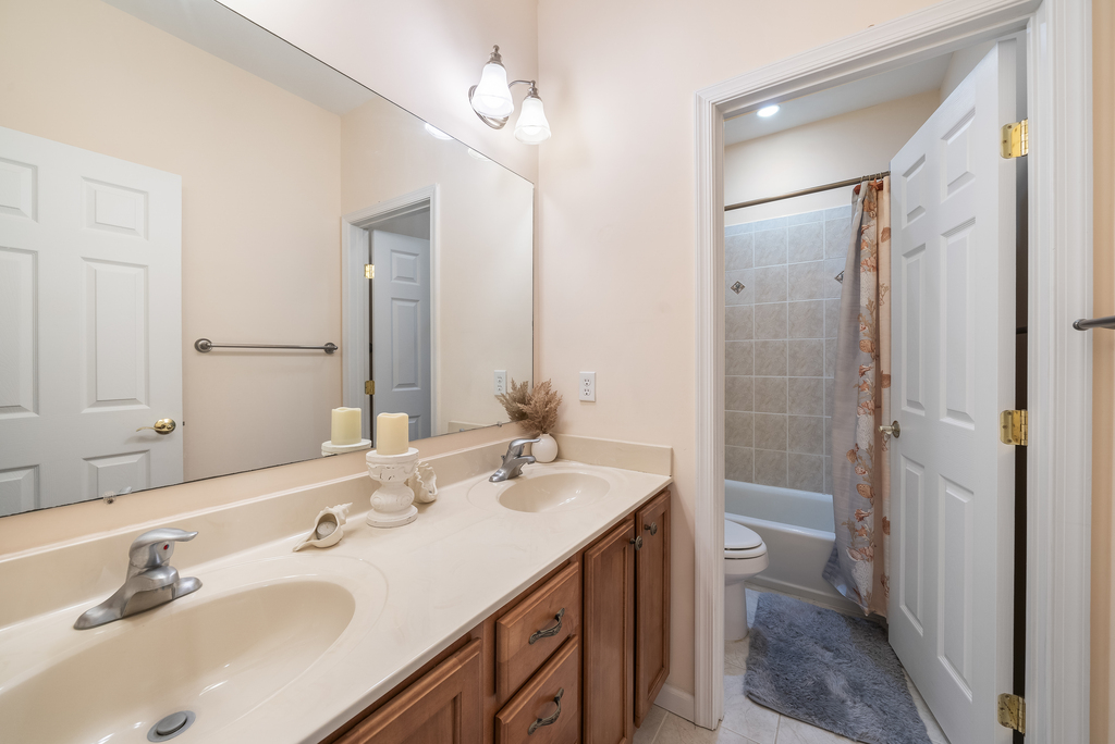 A Shared Full Bath is in the Hall with Double Vanity.