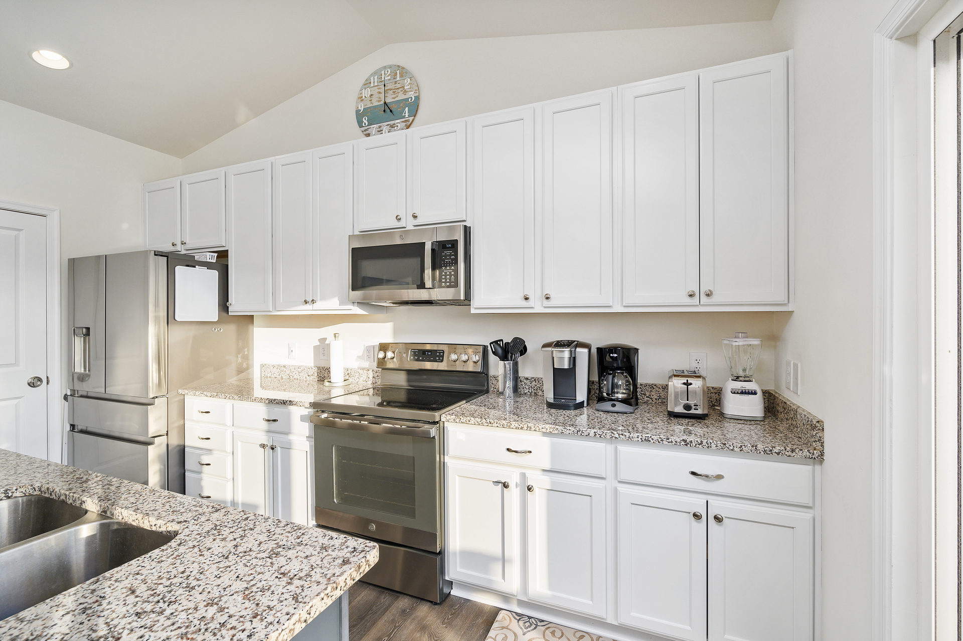 Beachy White Cabinetry, Stainless Appliances, and Granite Countertops.