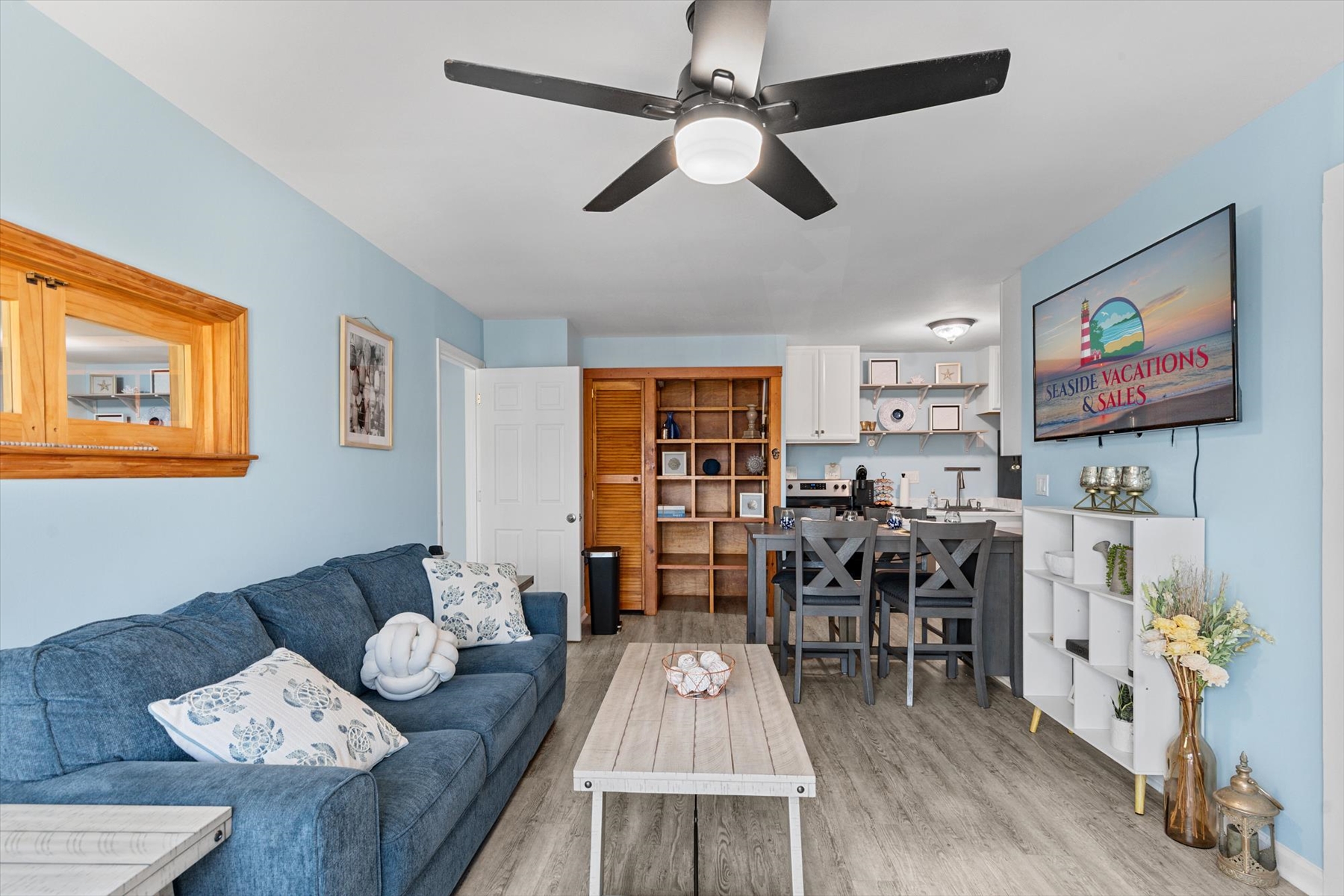 The main living space seamlessly transitions into an open kitchen and breakfast bar area, perfect for entertaining.