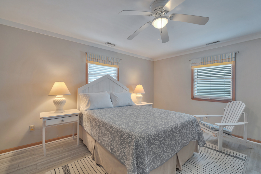 Primary Bedroom with comfy Queen Bed and beachy blue walls.