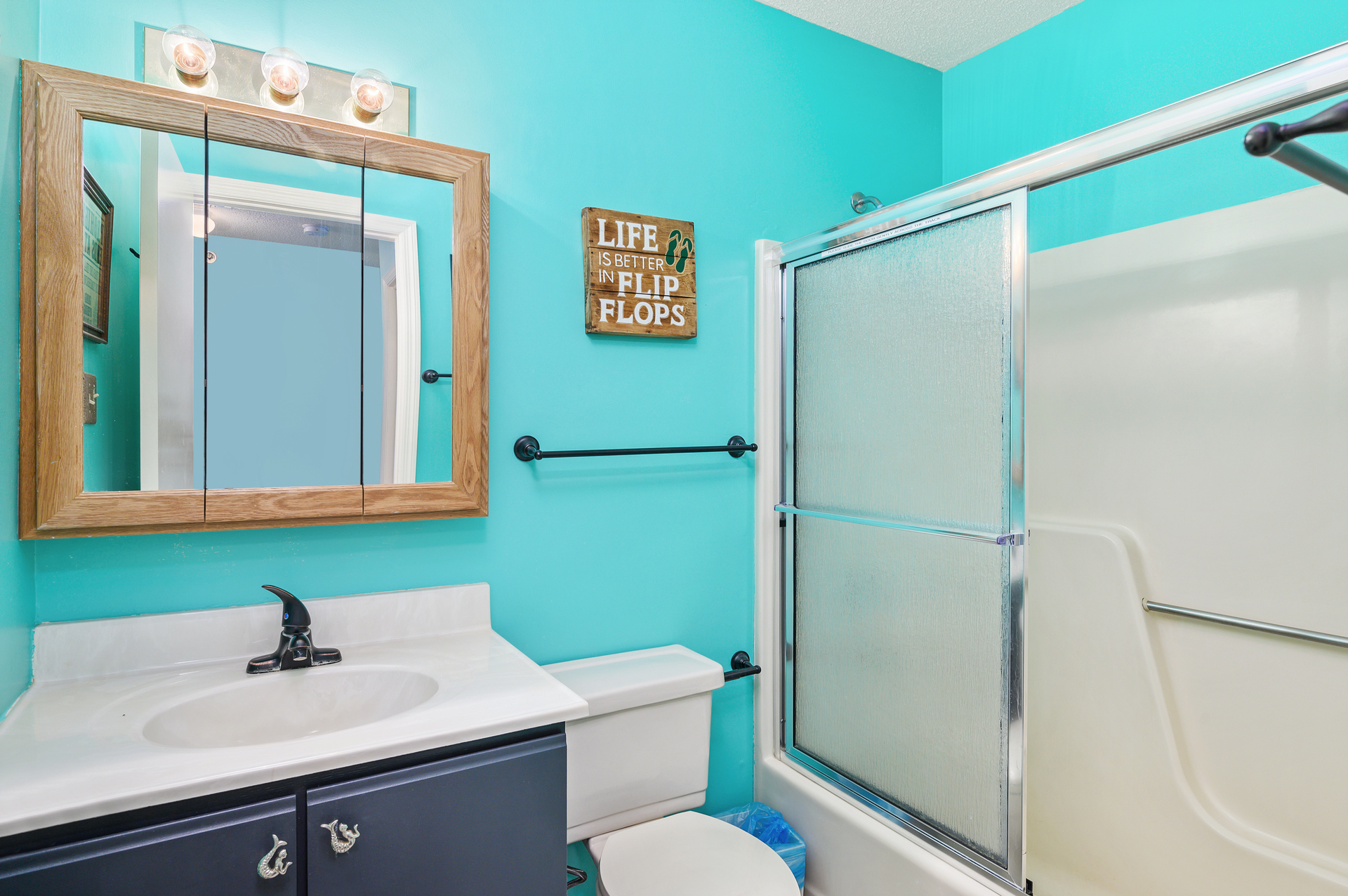 Shared full bathroom with walk-in shower.