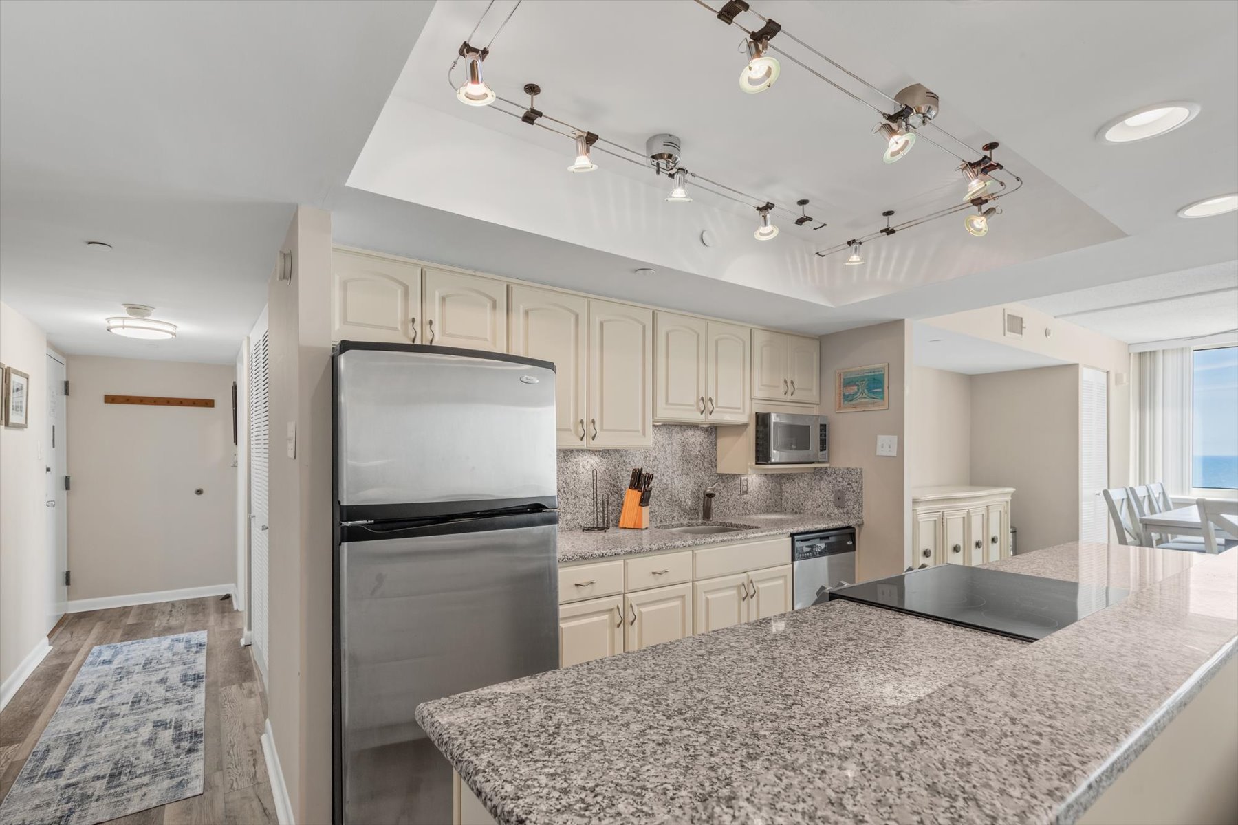 Featuring premium stone countertops, stainless steel appliances, and sleek track lighting to make meal prep a pleasure.