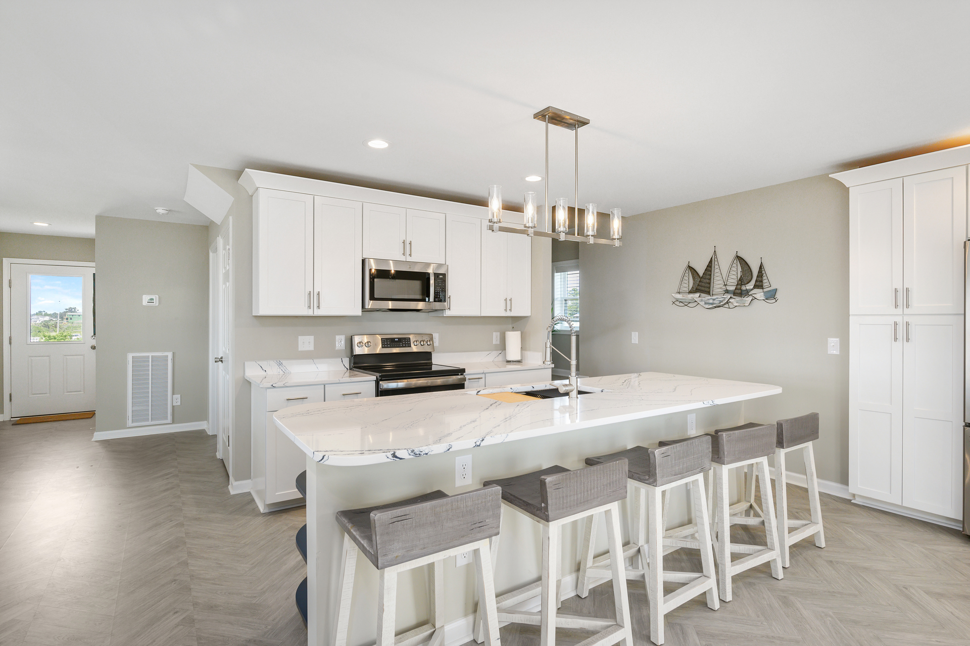 Gleaming Quartz Countertops and Stainless Appliances.