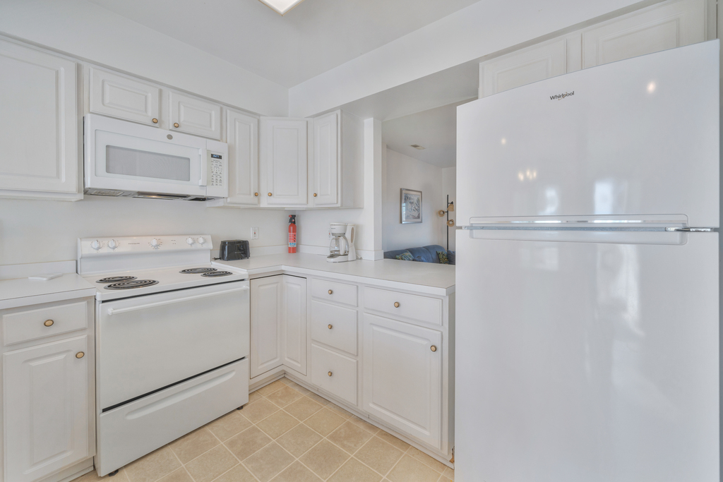 Kitchen is beachy and bright white - crisp and clean.