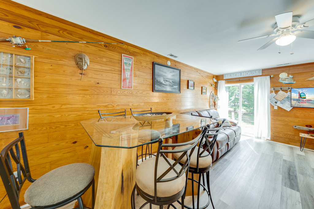 Stroll down to the Living Area with warm wood walls and lots of comfy seating.