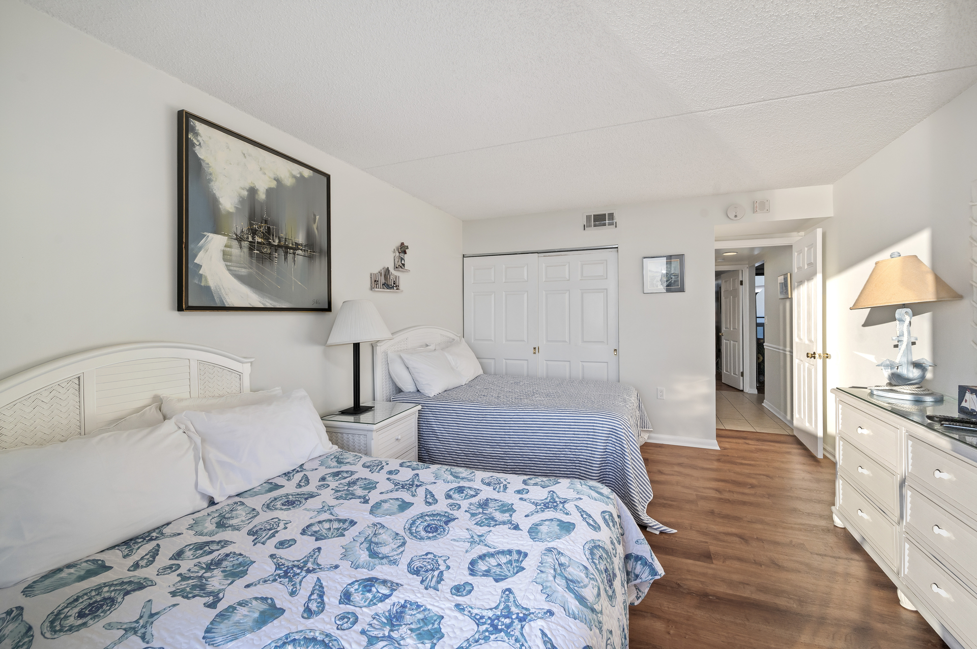 This Bedroom offers 2 Cozy Full Beds, a Flat Screen TV and Private Access to the Bay View Balcony!