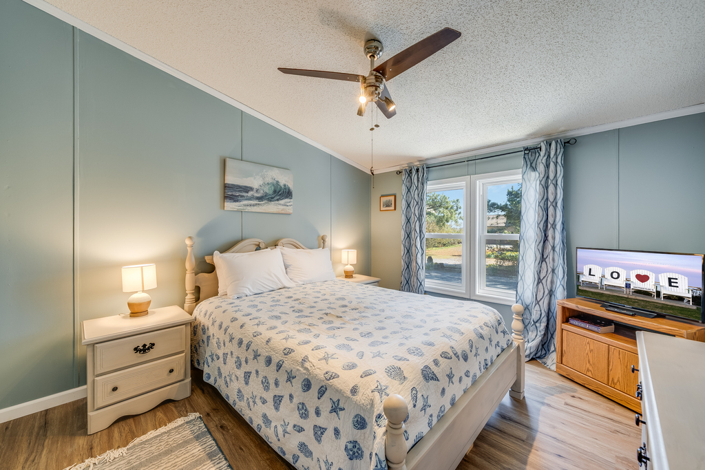 Bedroom 1 has a comfy Queen Bed and Coastal Flair.