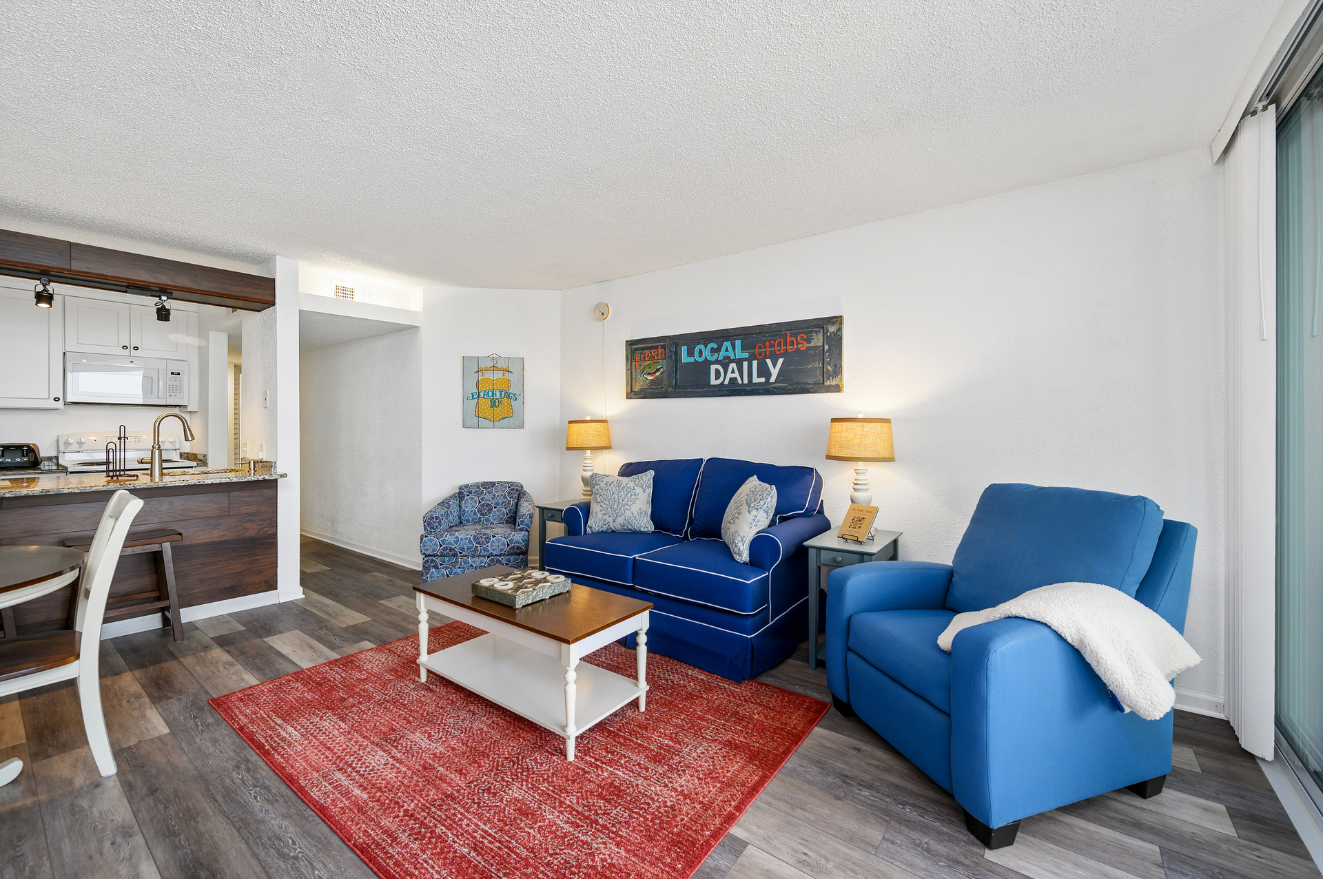 The open Living Area has lush and cozy furnishings.