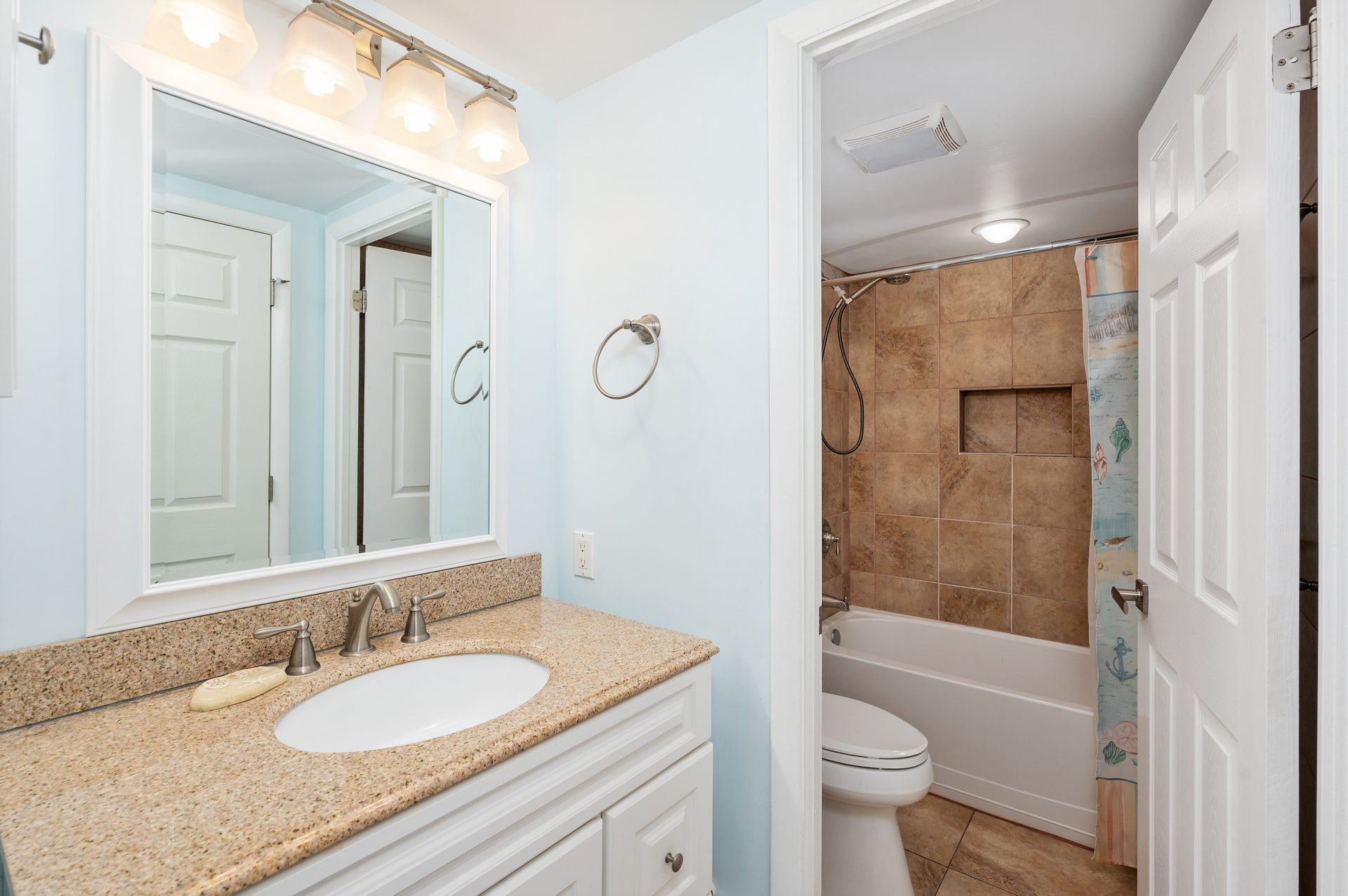 This Full Shared Bath is adorned in colors of Sand & Sea.