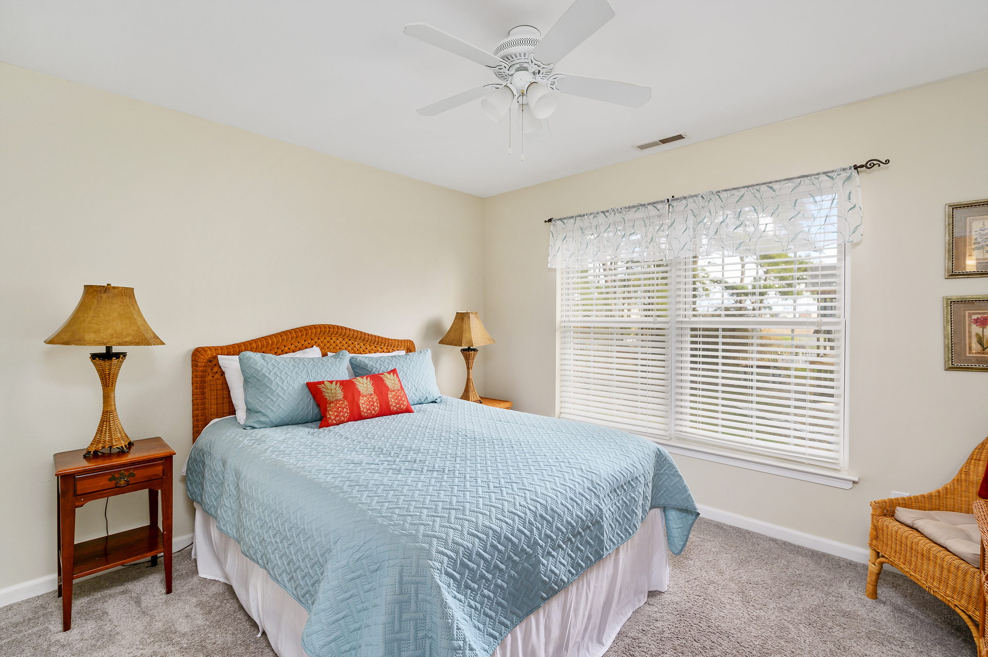 Bedroom 2 has a Queen Bed and serene Views of the yard.