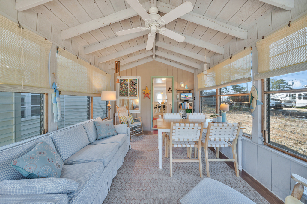 A Screened Porch with jalousie windows lines the back of Sunny Side Up. There is no AC on the Porch.