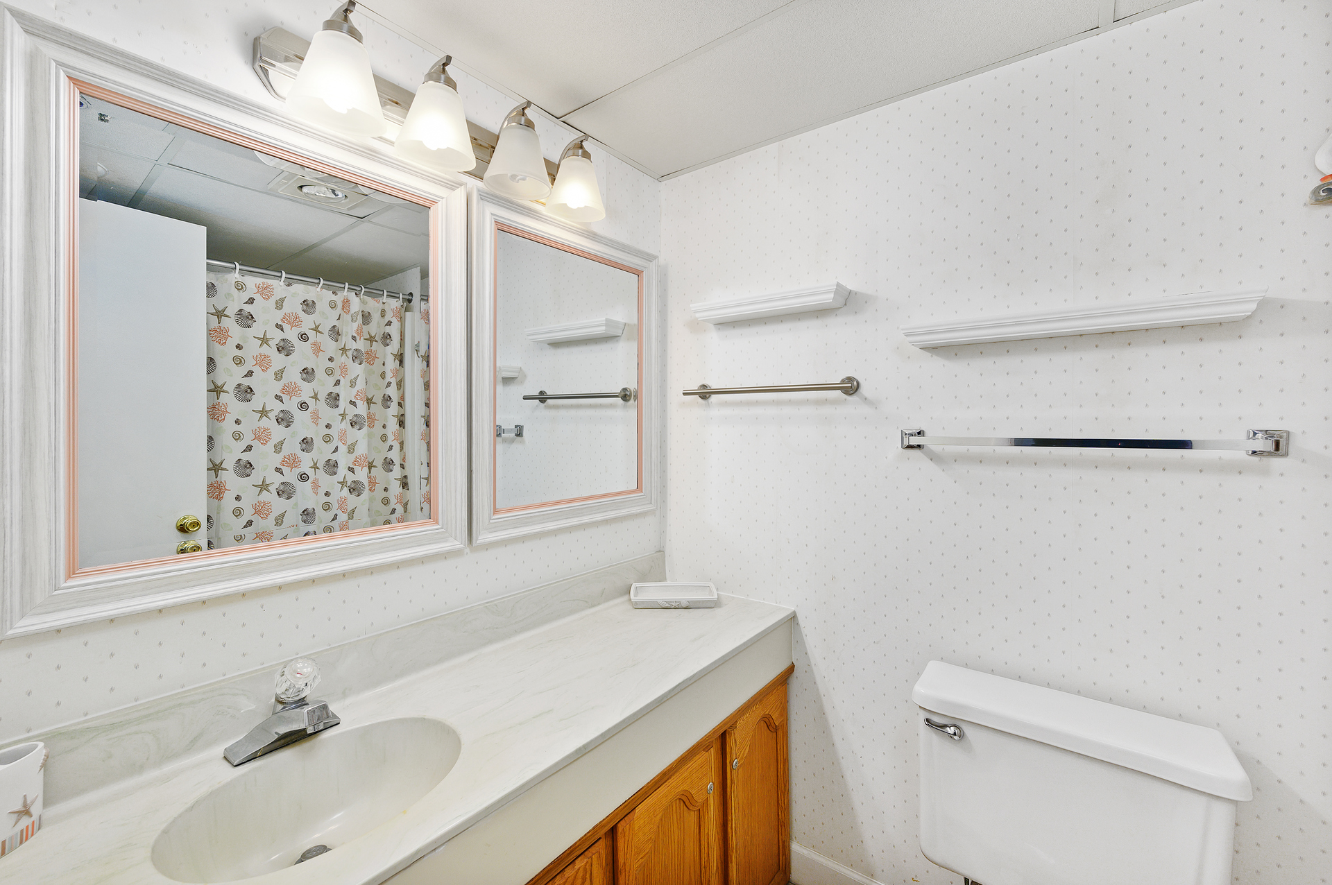The second bathroom also offers plenty of counter space and large mirrors