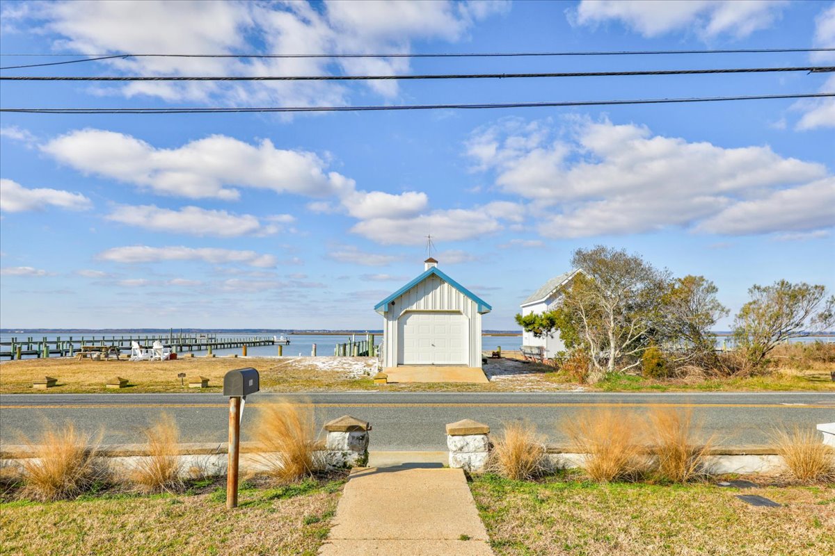 Looking from the house towards the Waterfront, Pier, and Fire Pit. Also, and Extra Parking Spot in front of the Boat House.