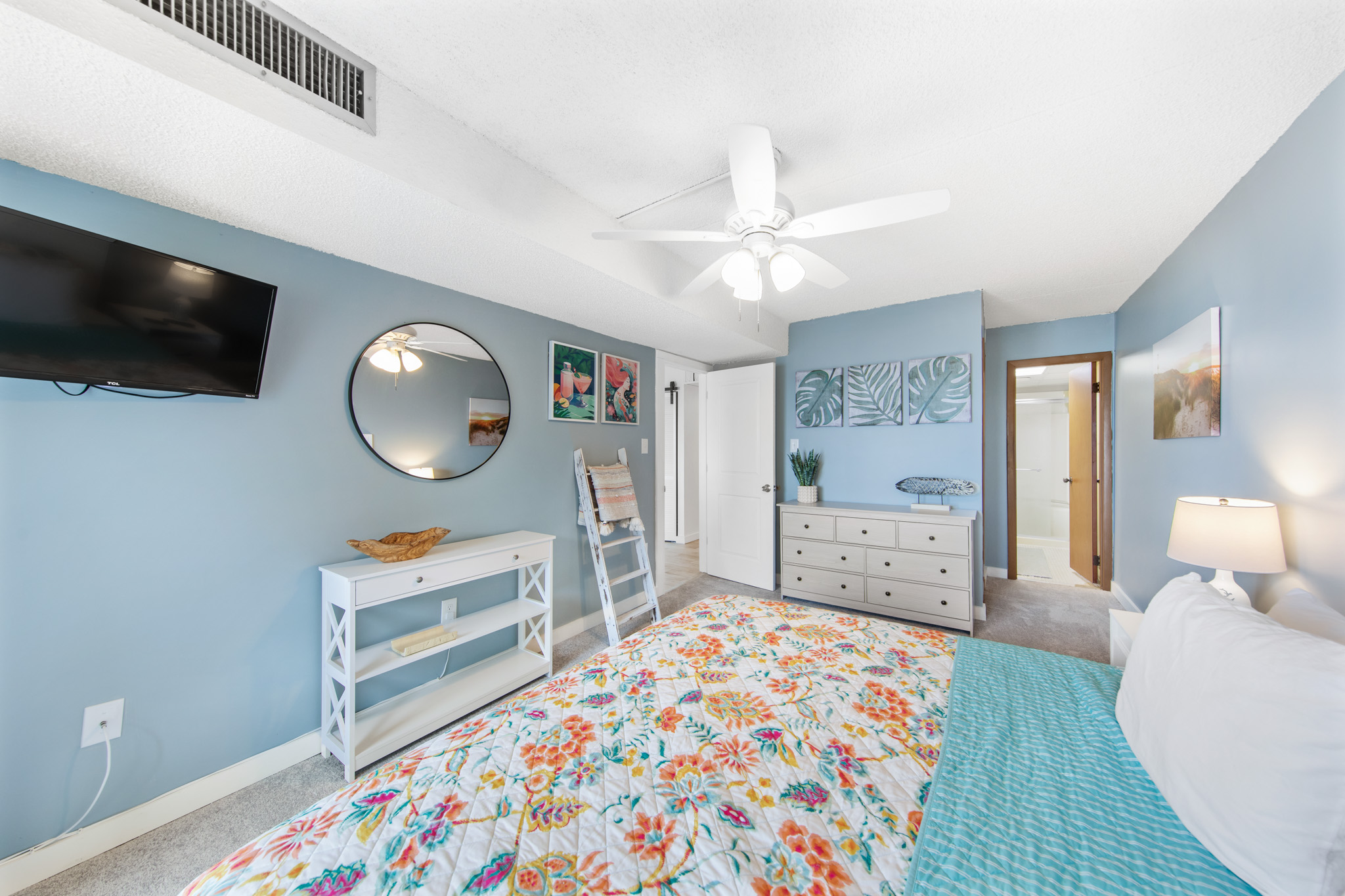 The Beachy decor is warm and welcoming in he Primary Bedroom