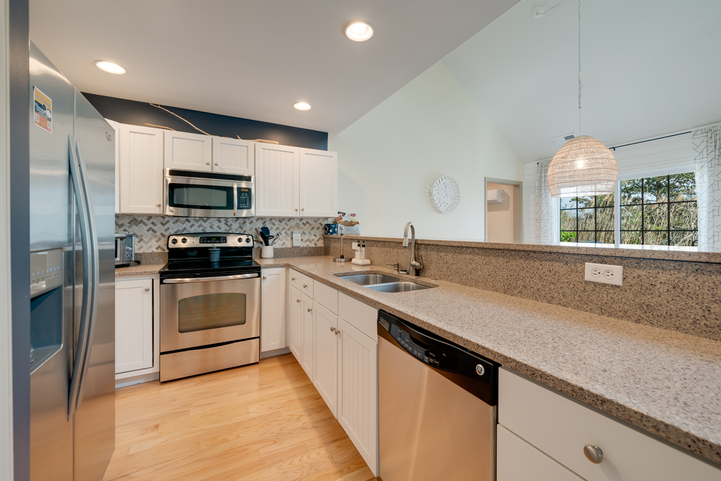 Updated Kitchen with Stainless Appliances and beachy white cabinetry.