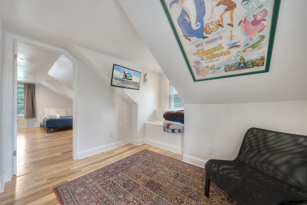 Wandering upstairs, you'll find a small area with another Flat Screen TV and Seating Area.