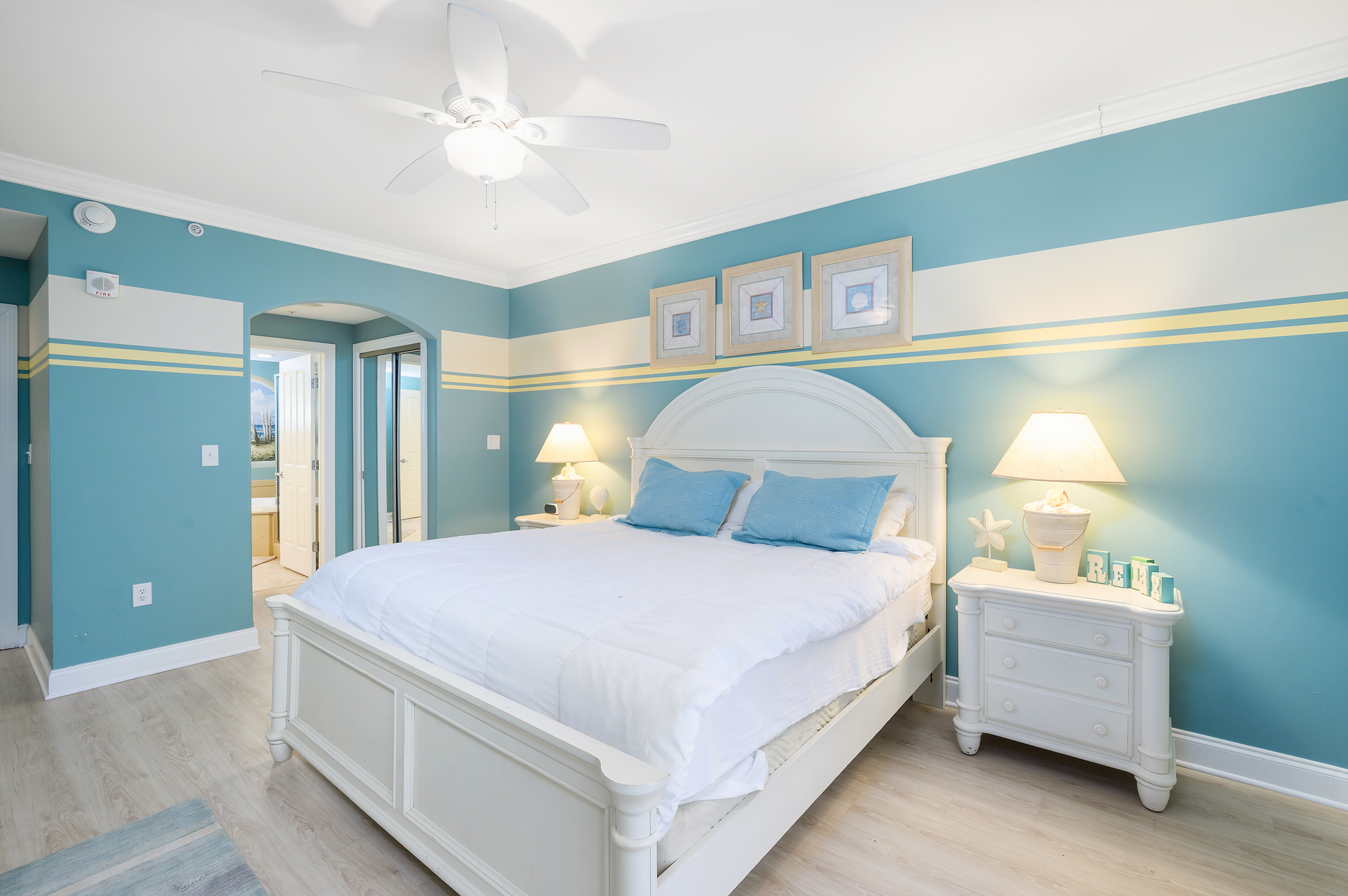 The Primary Bedroom carries the feel of the beautiful scene outside with its cool sky blue and sand tones.