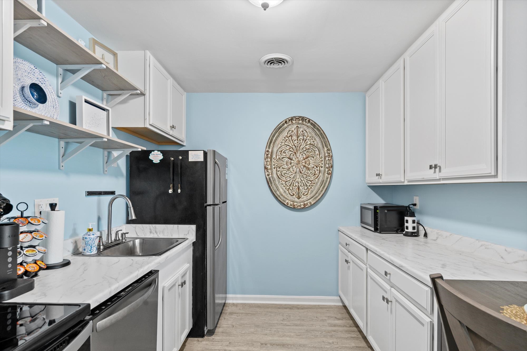 A crisp view down the center of the kitchen, showcasing the convenient dual-sided counter setup.