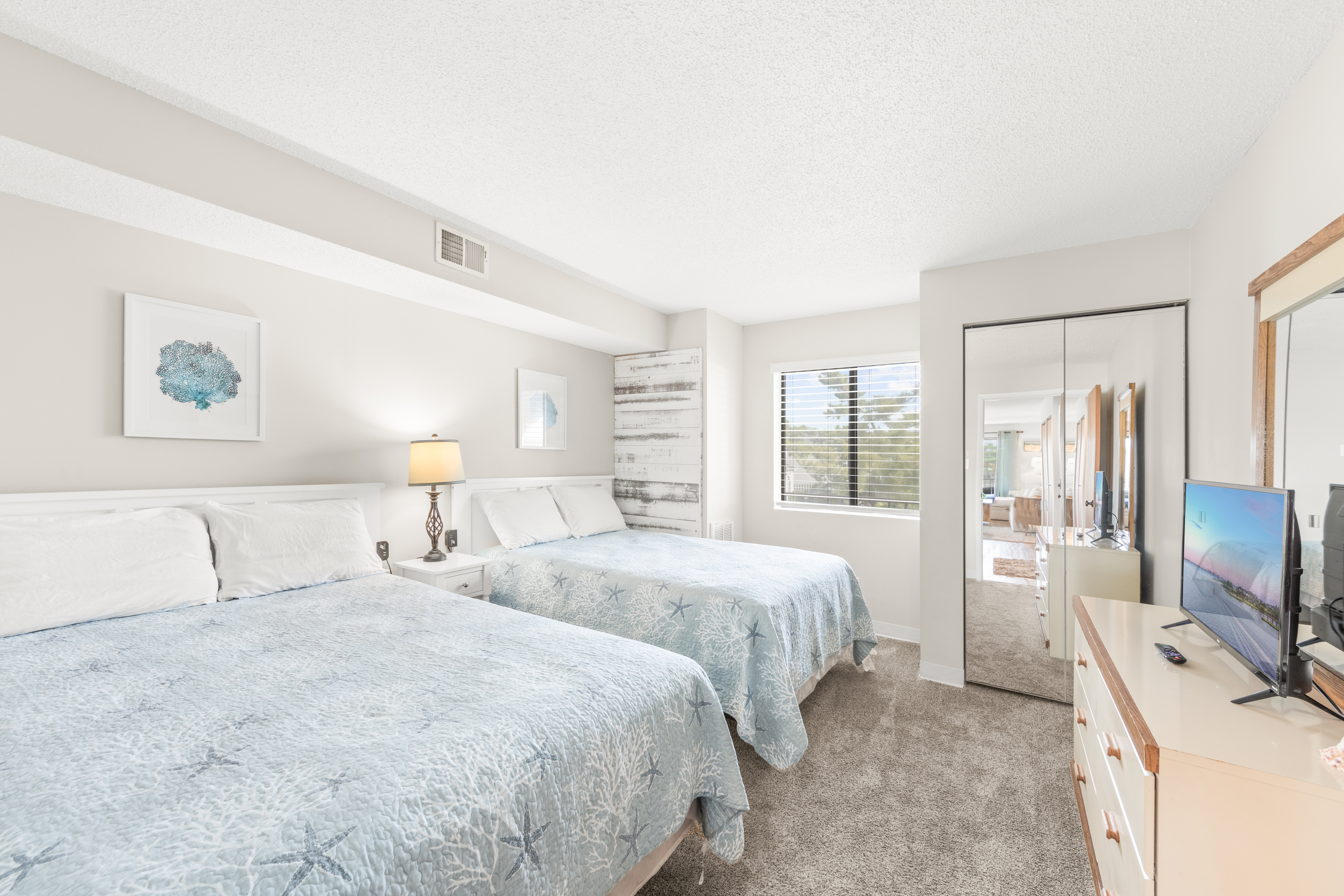 Bedroom 1 is adorned in colors of Sand and Sea!