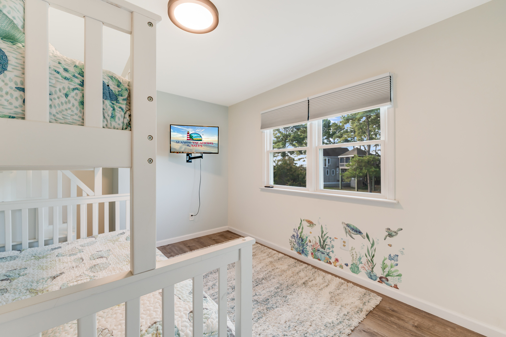 Bedroom 3 has a fun Coastal Mural on the wall, and Flat Screen Smart TV.