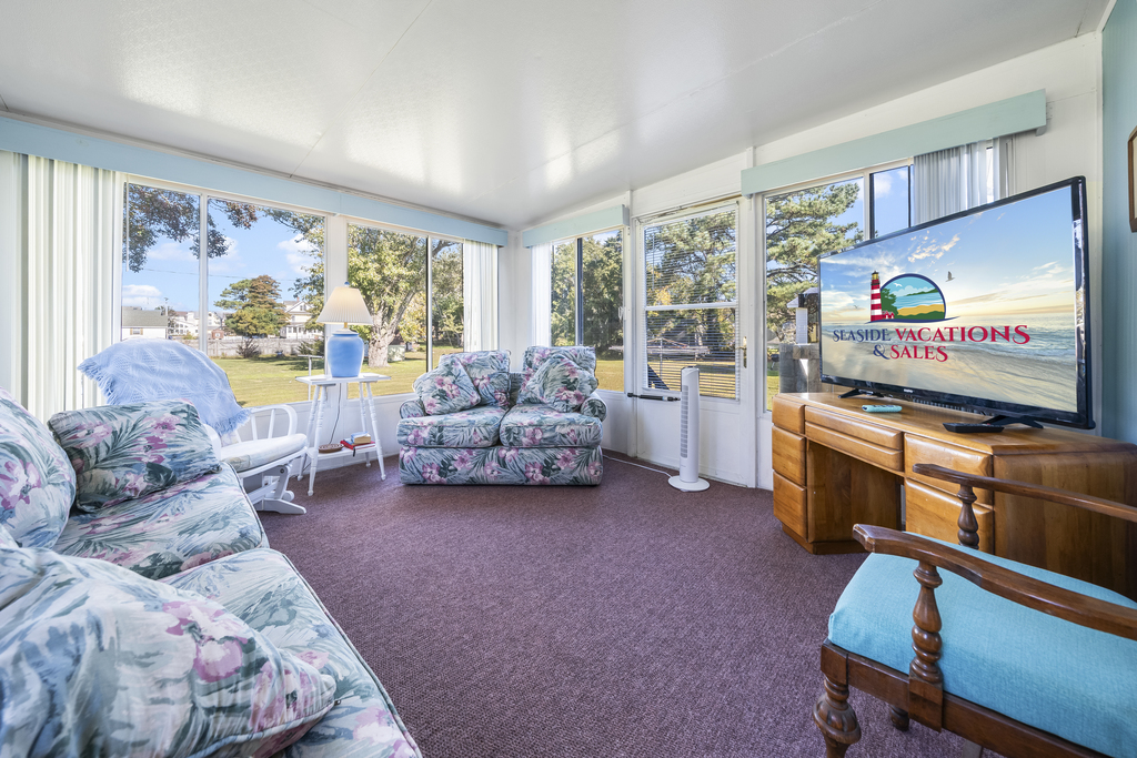 A Sunroom lines the back of the house - this area is not heated or cooled, but lets in gorgeous sea breezes when the windows are open!
