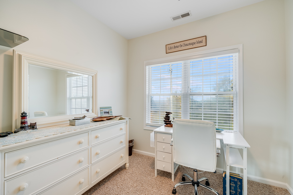 The Primary Bedroom also has a office featuring a spacious desk by the window, perfect for productive mornings with natural light streaming in.