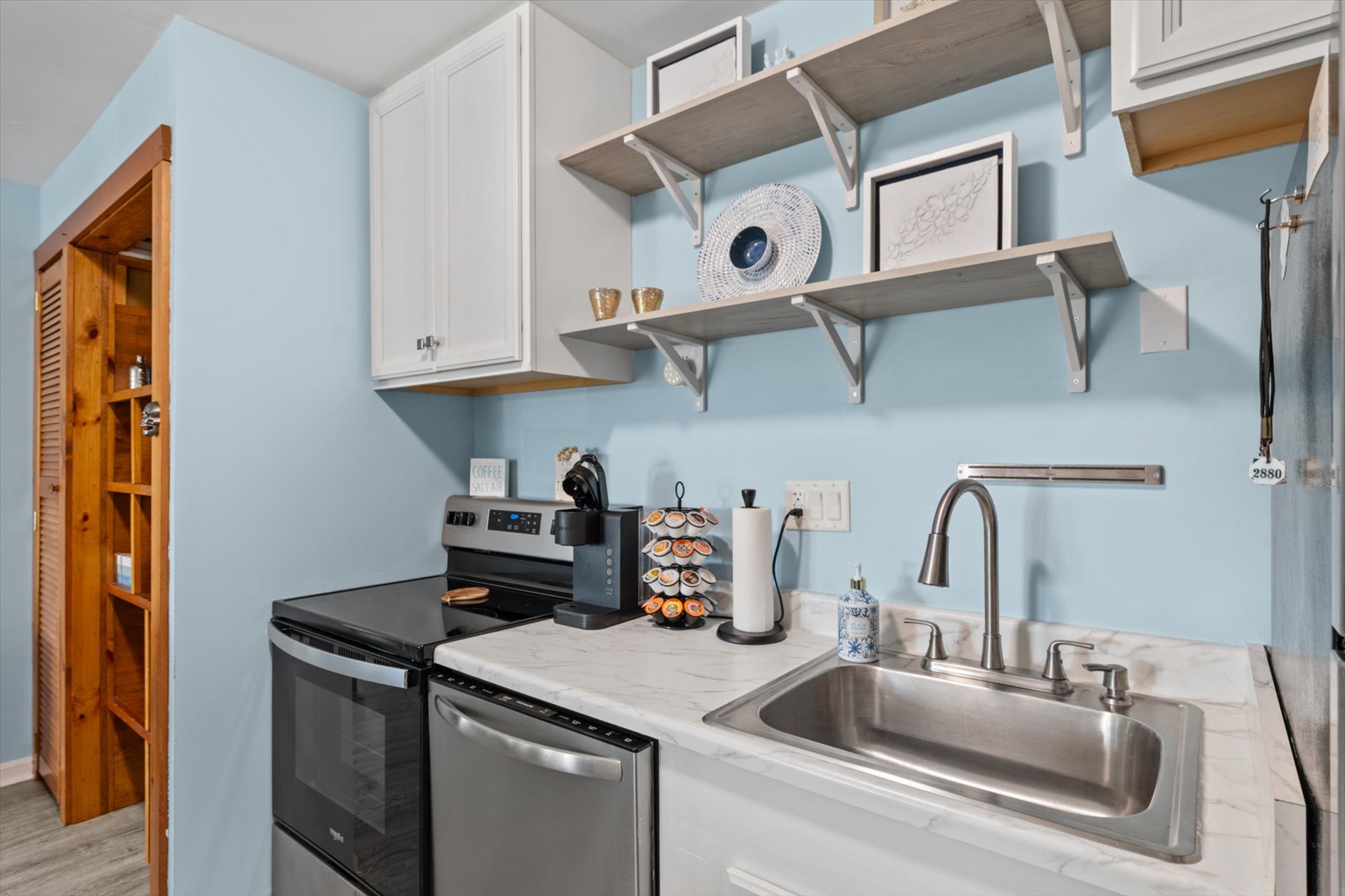 Prepare your morning brew at the handy countertop coffee station right next to the stainless steel sink.