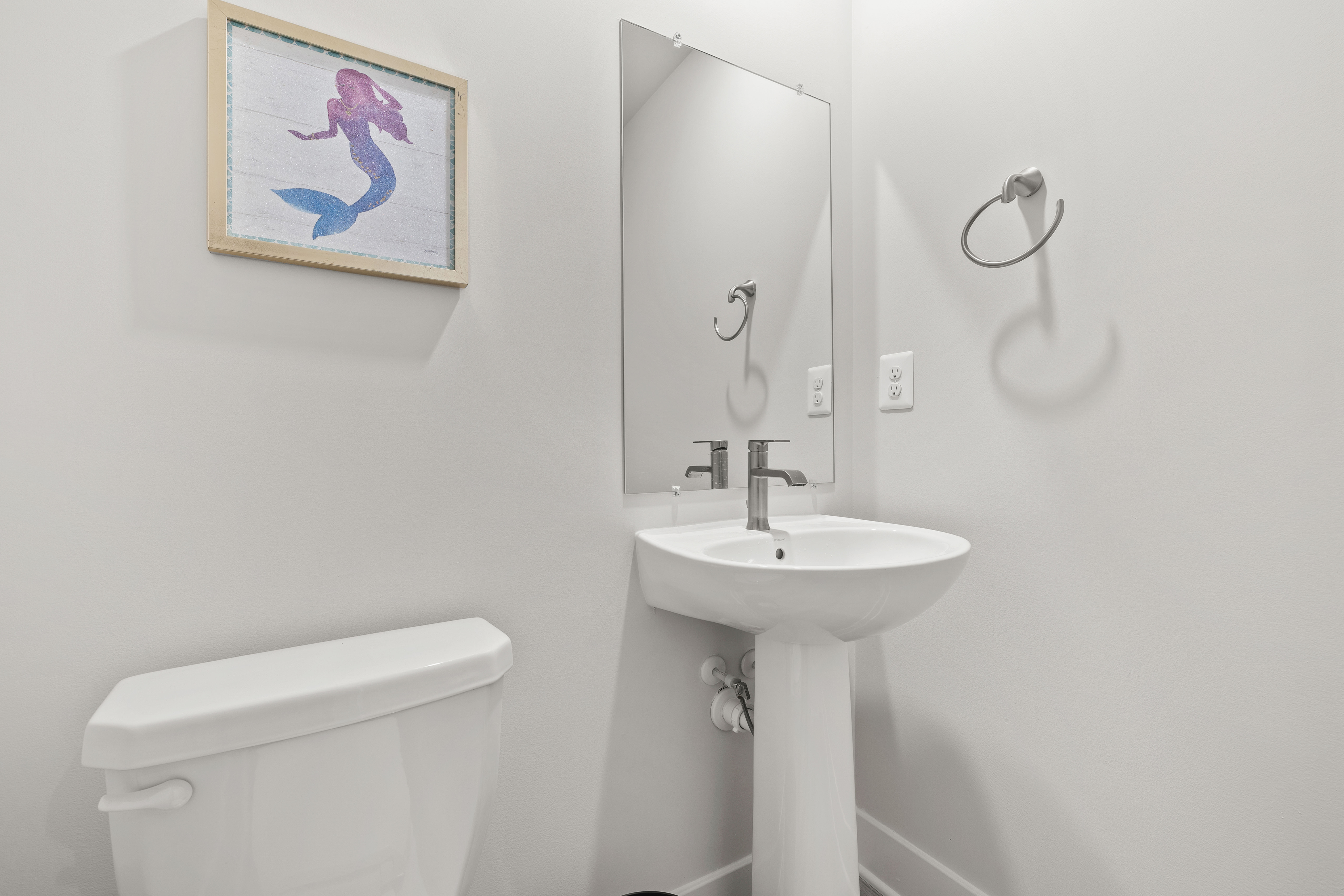 Modern half bath located on the 1st floor.