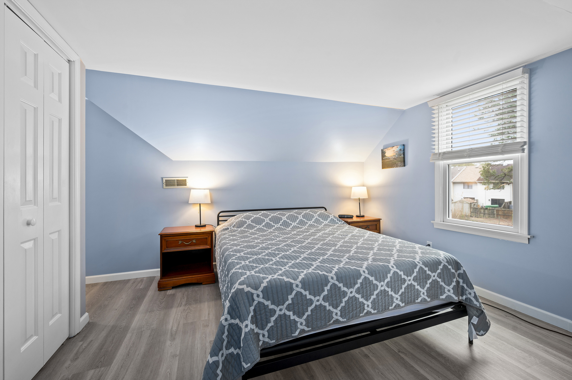 Bedroom 2 has a Queen Bed and soothing grays.