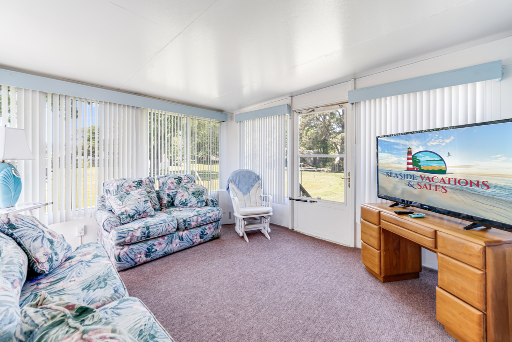 A Sunroom lines the back of the house - this area is not heated or cooled, but lets in gorgeous sea breezes when the windows are open!