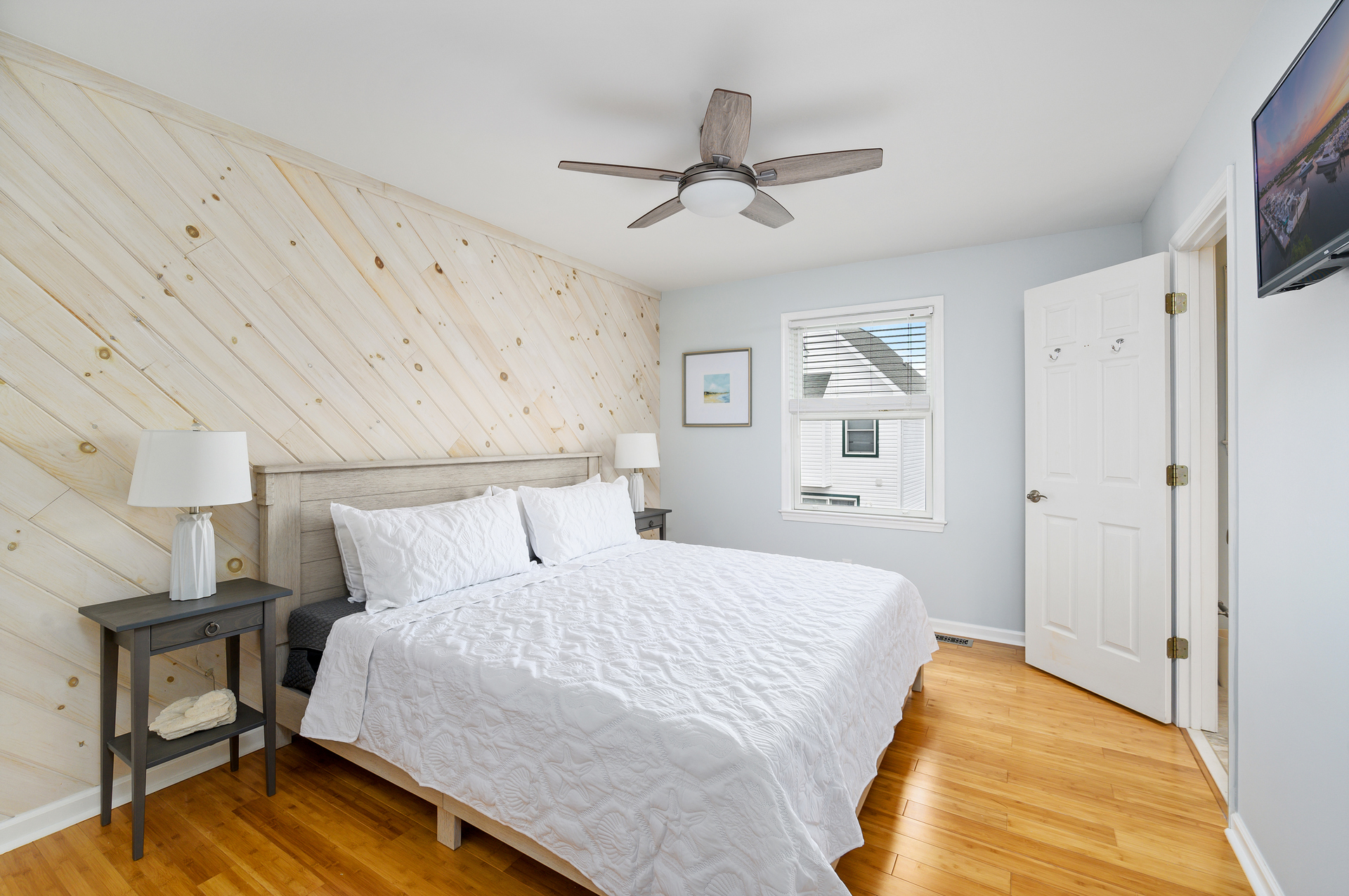 Driftwood's Primary Bedroom has a plush King sized bed and a stunning shiplap wall