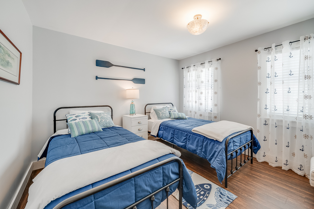 Bedroom 2 is dressed in beachy blues and has 2 Twin Beds.