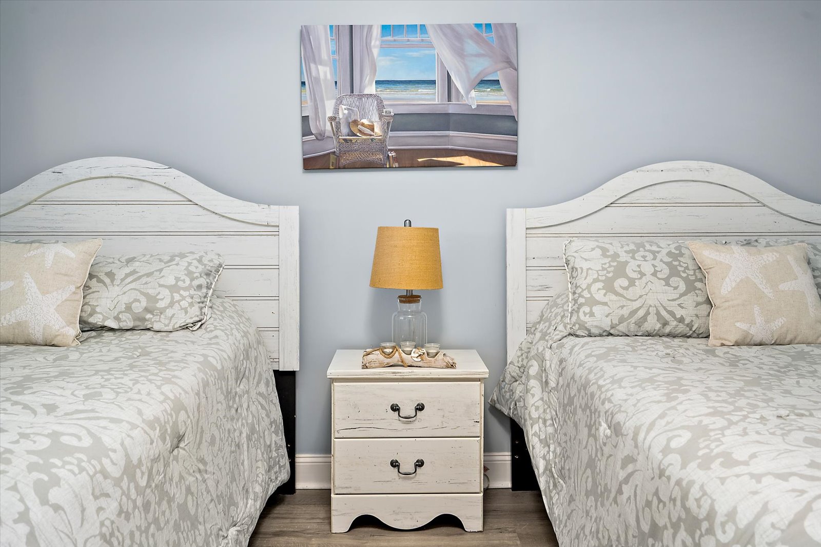 Thoughtfully arranged with a shared nightstand and matching coastal-themed bedding to make everyone feel right at home.