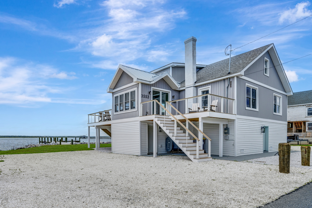 This stunning home sits right on the water's edge!