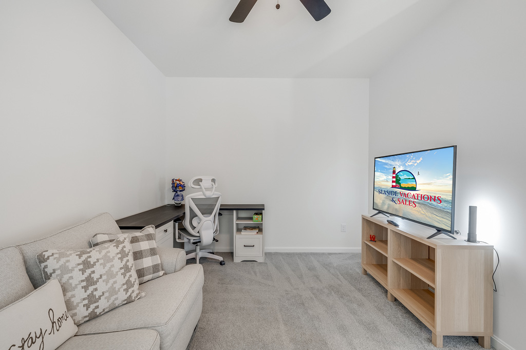 Den with additional seating, Smart TV, and Work Station.
