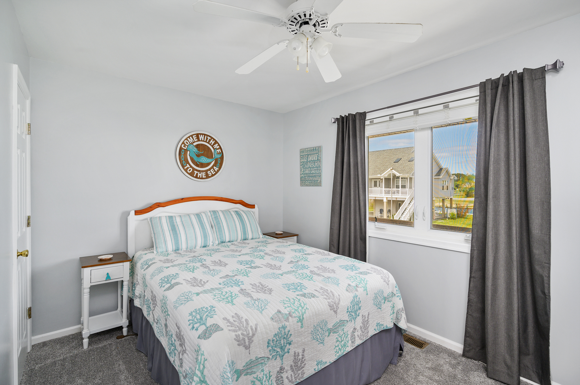 Bedroom 2 has a Coastal Flair and a Queen Bed.