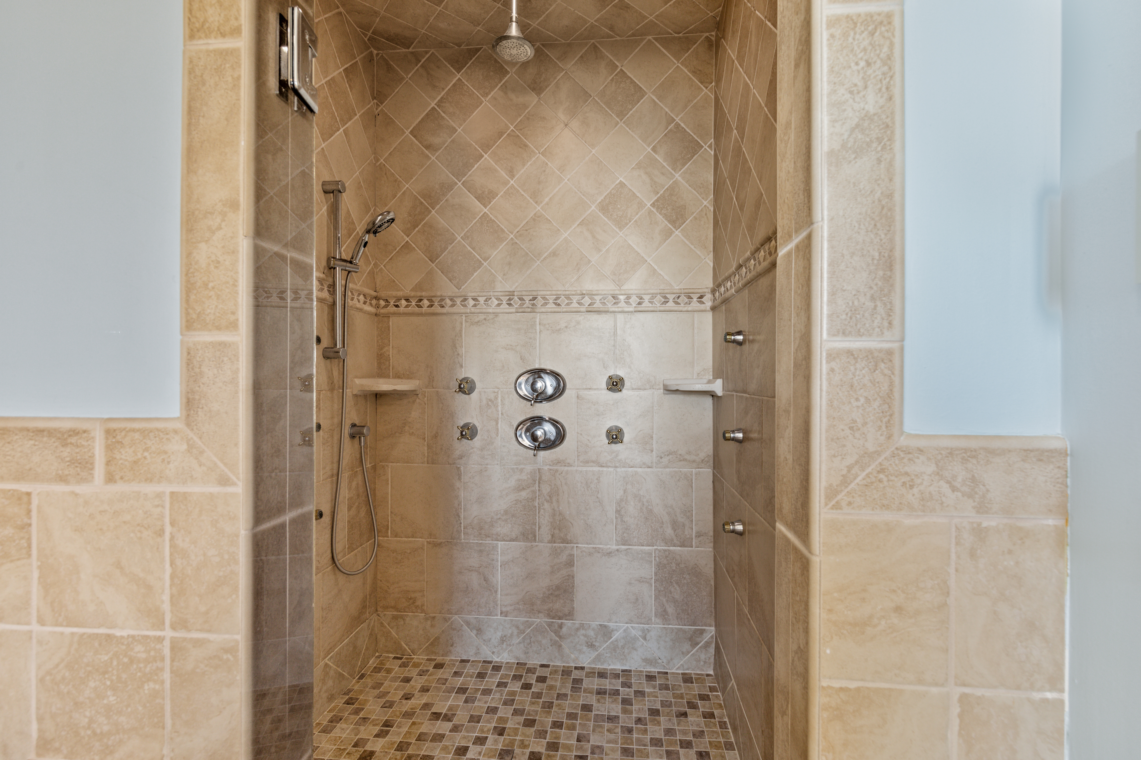This Walk-in Shower is what dreams are made of with multiple shower heads and Rain Shower Option.