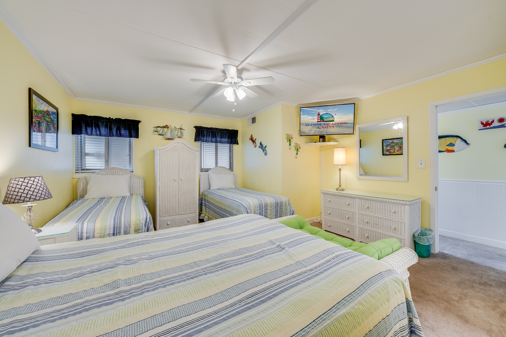 A welcoming bedroom designed for family bonding and relaxation after a long day at the beach.