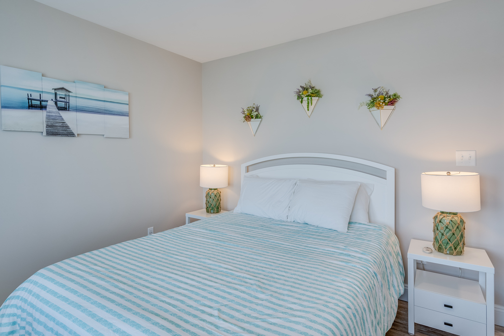 Bedroom 2 also has a Queen Bed and Beachy Decor.