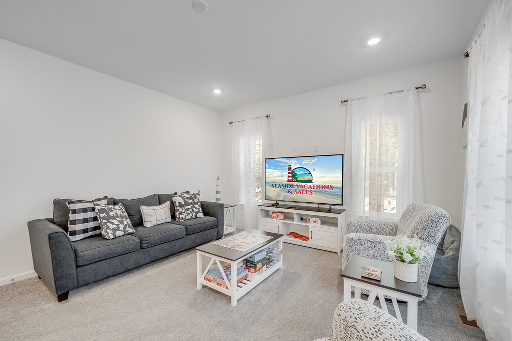 Relax in the Living Area with comfy furnishings and Flat Screen Smart TV.