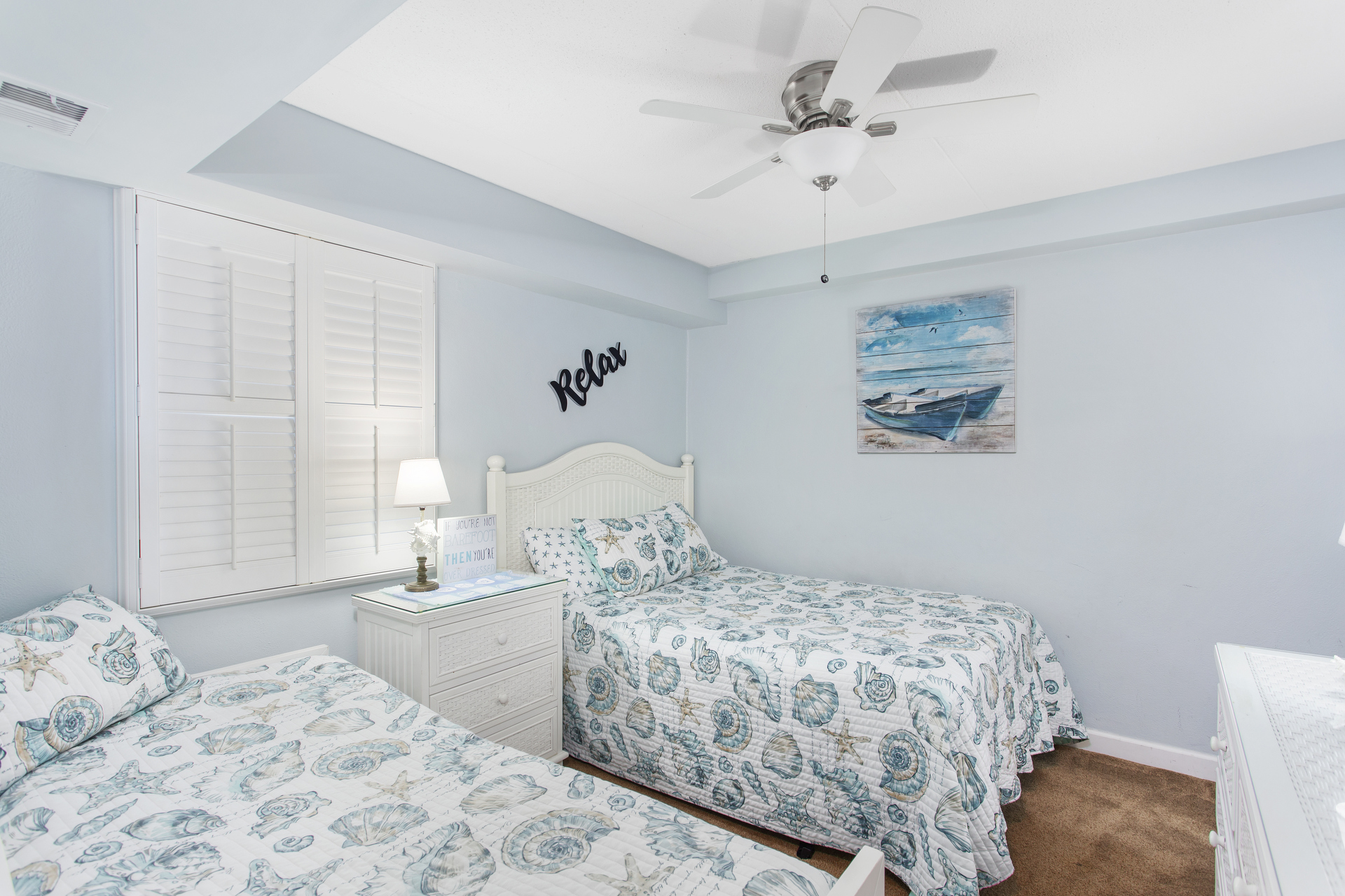 The Den has a Coastal Flair with a Twin and a Full bed.