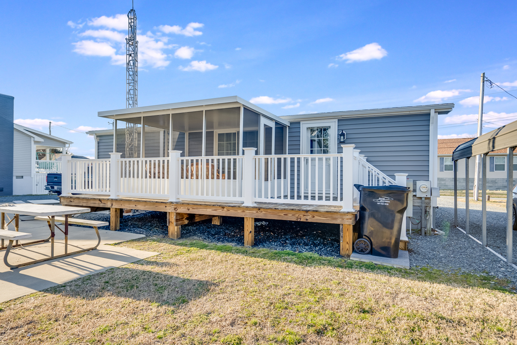 Spacious Deck with screened in porch lines the back of the house.