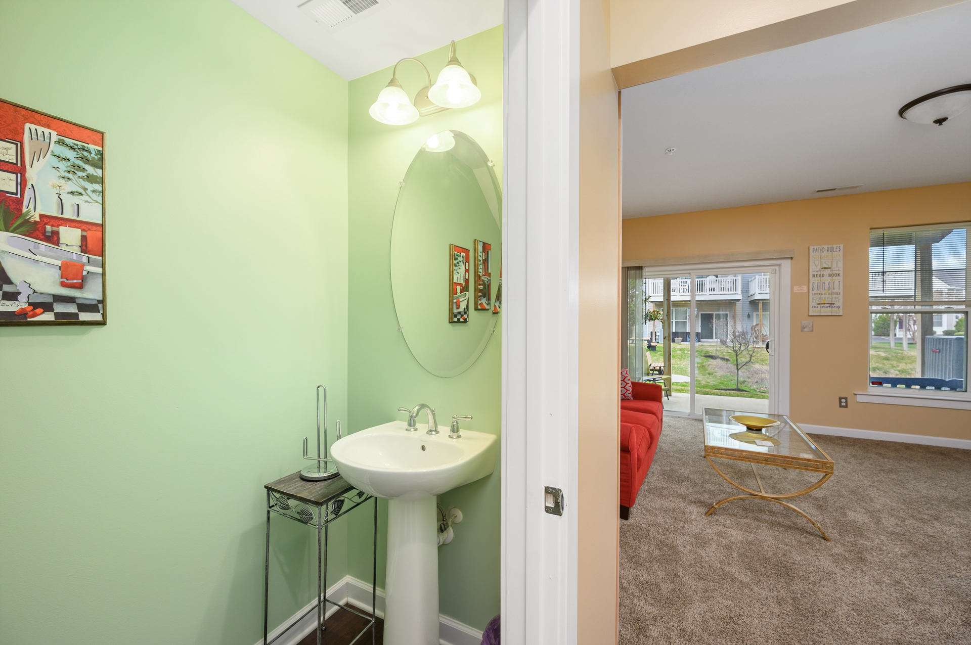 This ground floor half bath is located near the additional living room directly across from the beautiful walk-in shower
