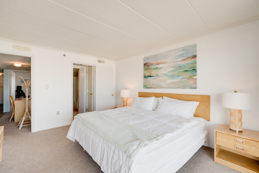 Primary bedroom features a king size bed that you won't be able wait to crawl into after a long day at the beach.