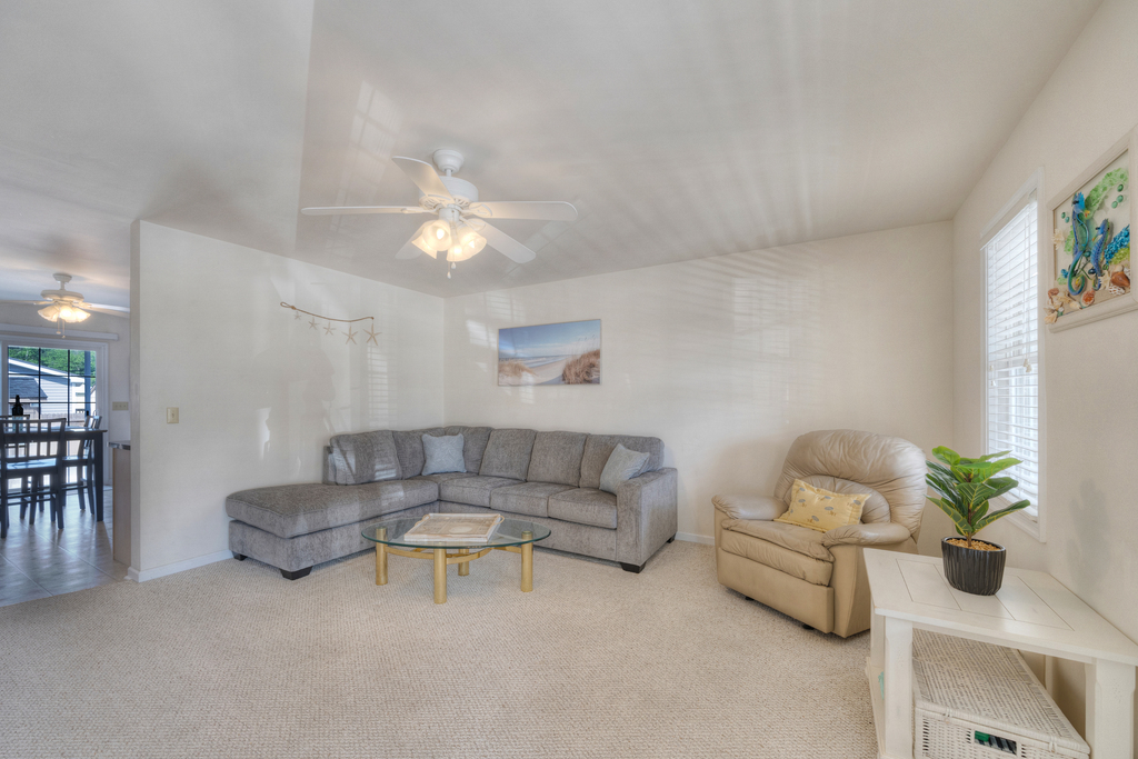 Relax in the Living Area with comfy furnishings and tons of natural light.