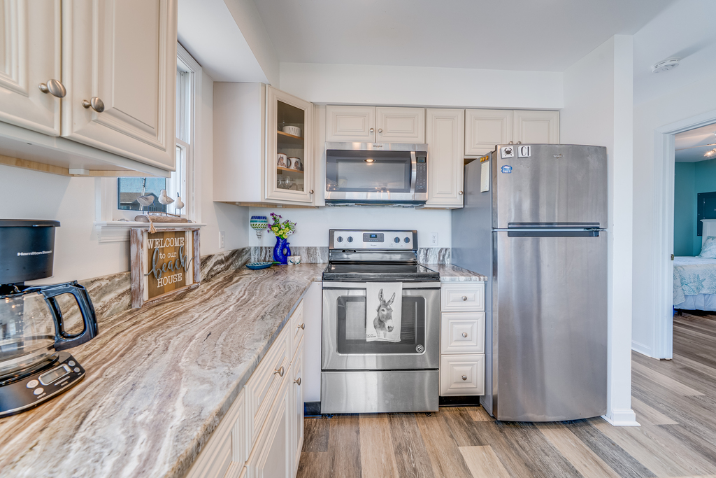 Stainless Appliances and gleaming solid surface countertops.