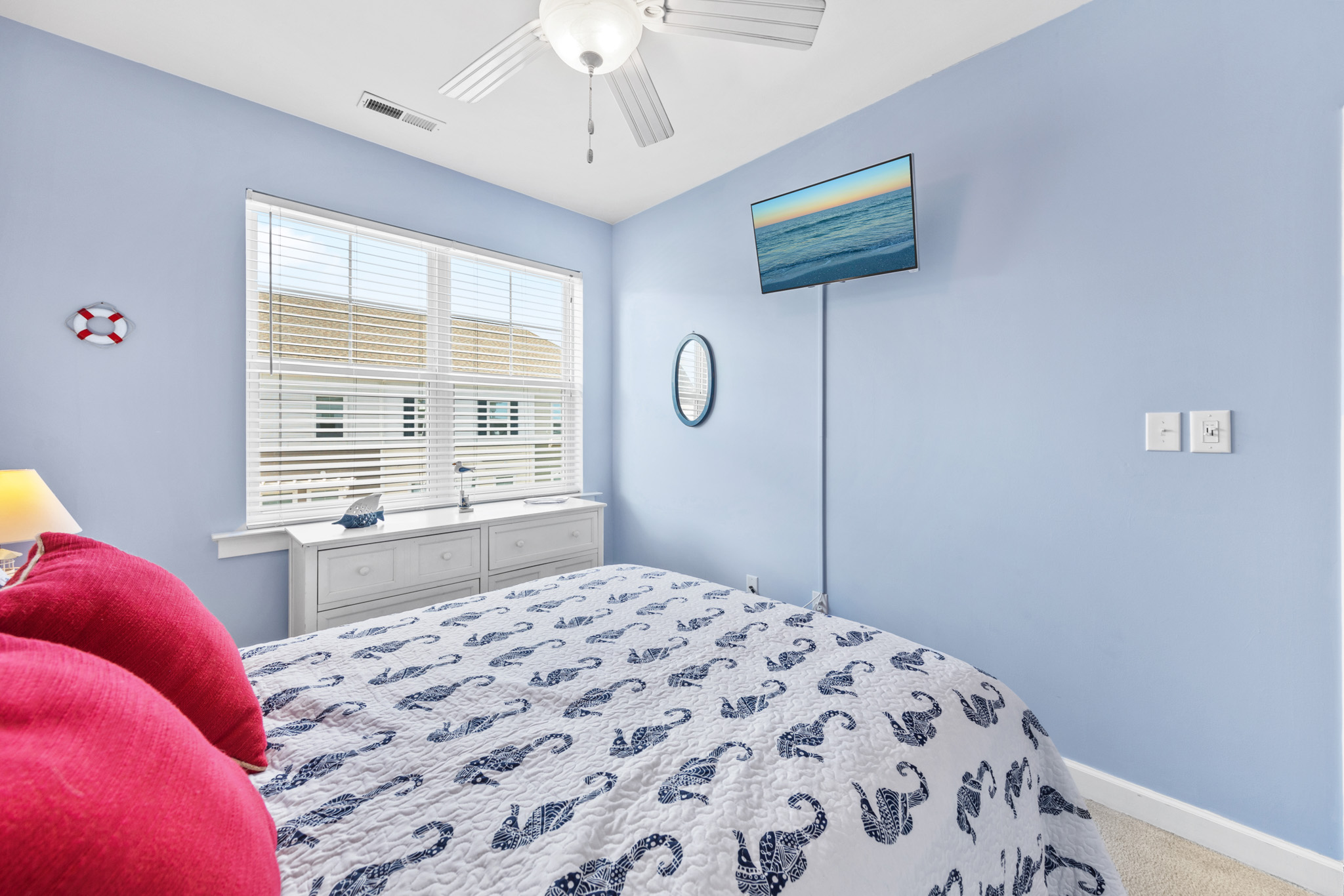 This bedroom has a full bed and flat screen TV.