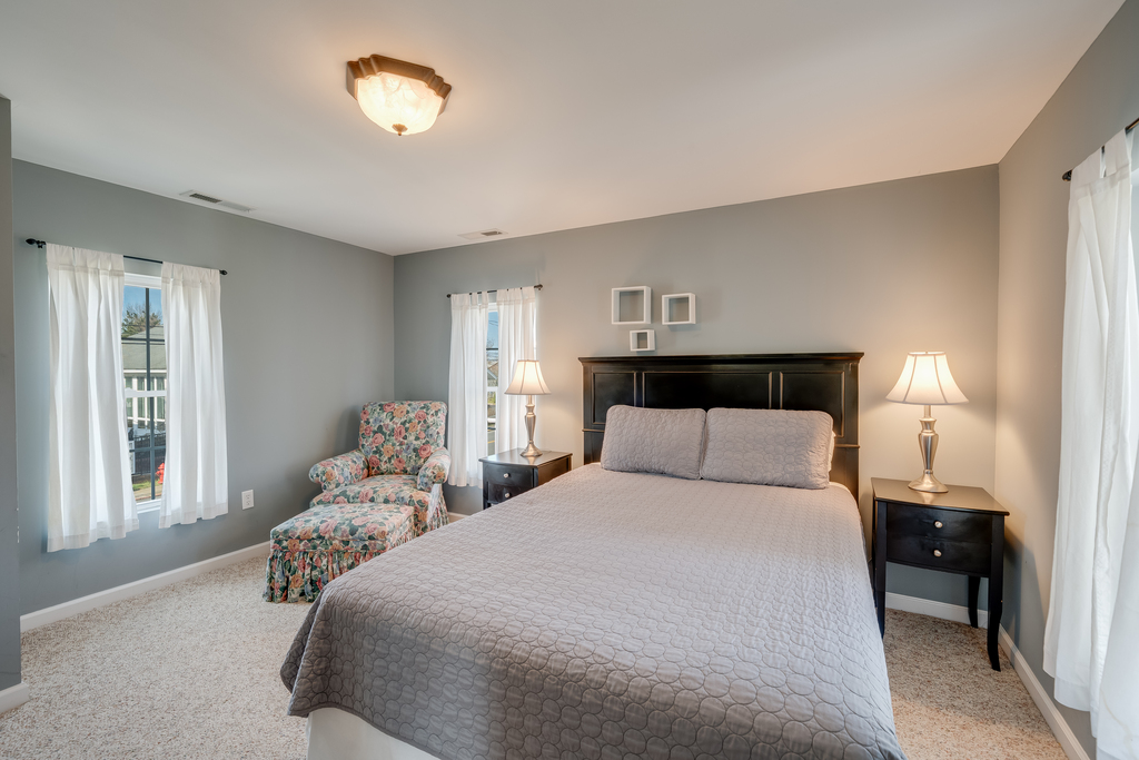 Upstairs, Bedroom 2 has a Queen Bed and muted tones pull from nature itself.