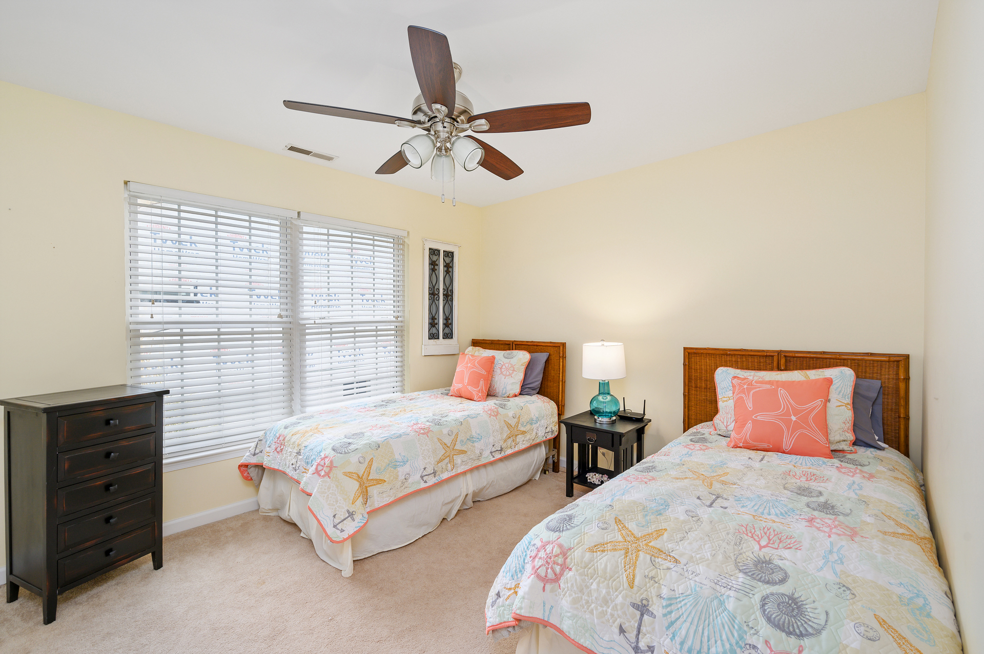 Bedroom 1 has 2 comfy Twin Beds, Flat Screen Streaming TV, and a bright, beachy theme.